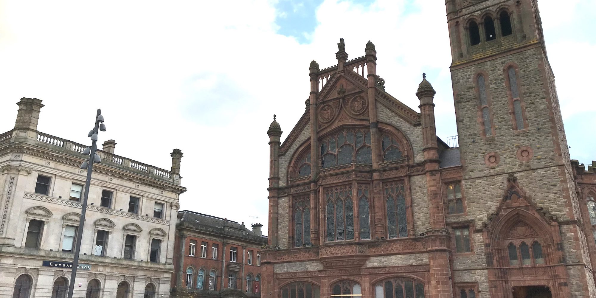 Gothic style red brick and stone building with spire to right, smaller sandstone and redbrick buildings to left. ‘Unlocking Heritage-led Prosperity’, a conference discussing a heritage development strategy for the city