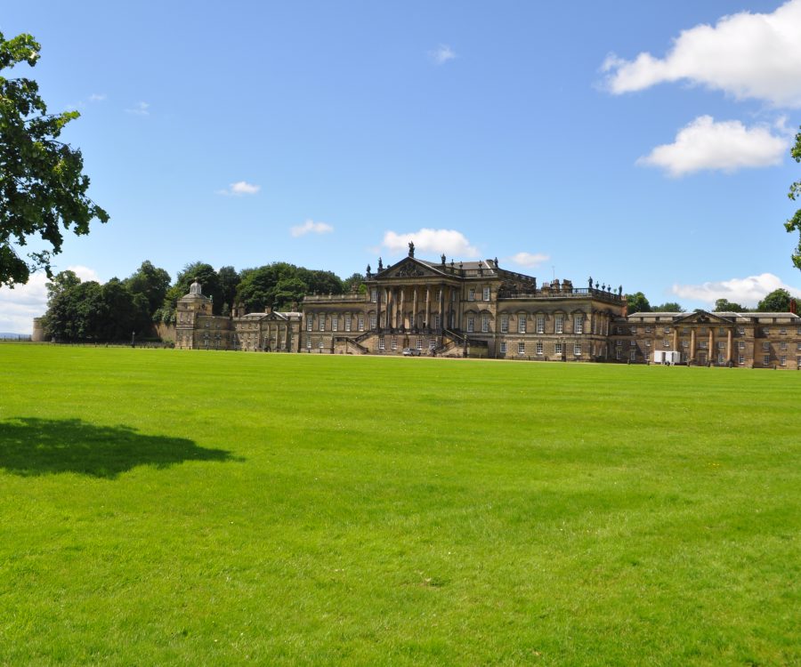 Front of stately home with lawns to the foreground