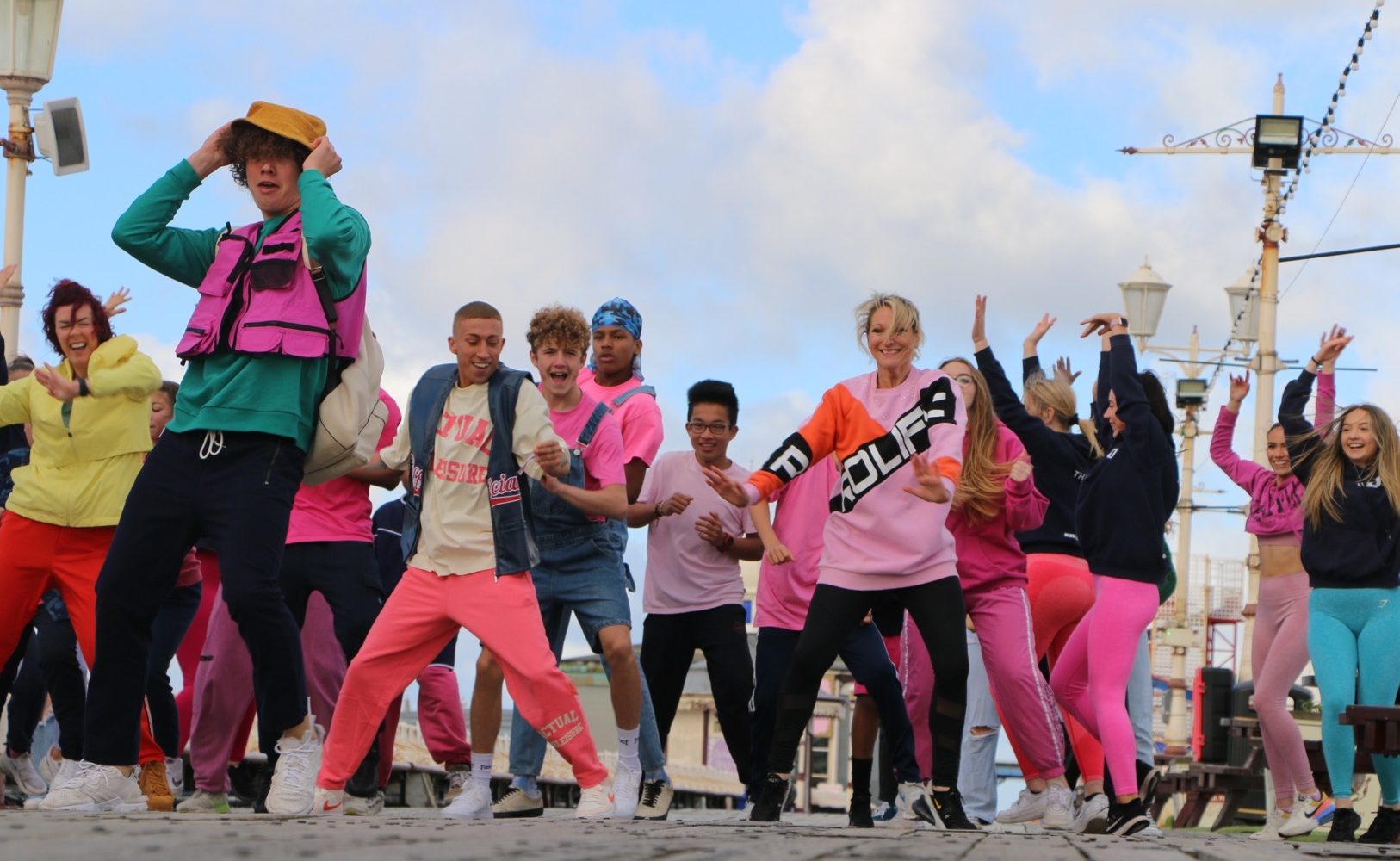 A group of people dance on the Blackpool Promenade