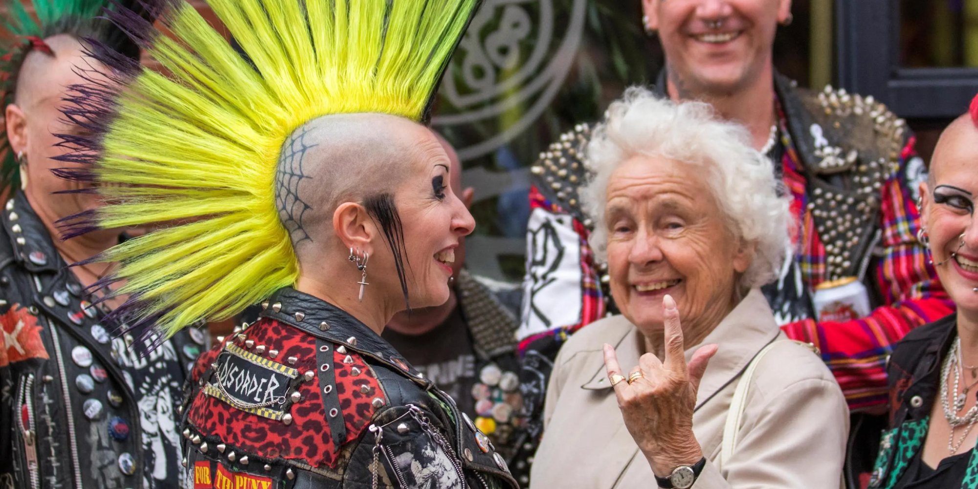 An older woman faces the camera displaying a 