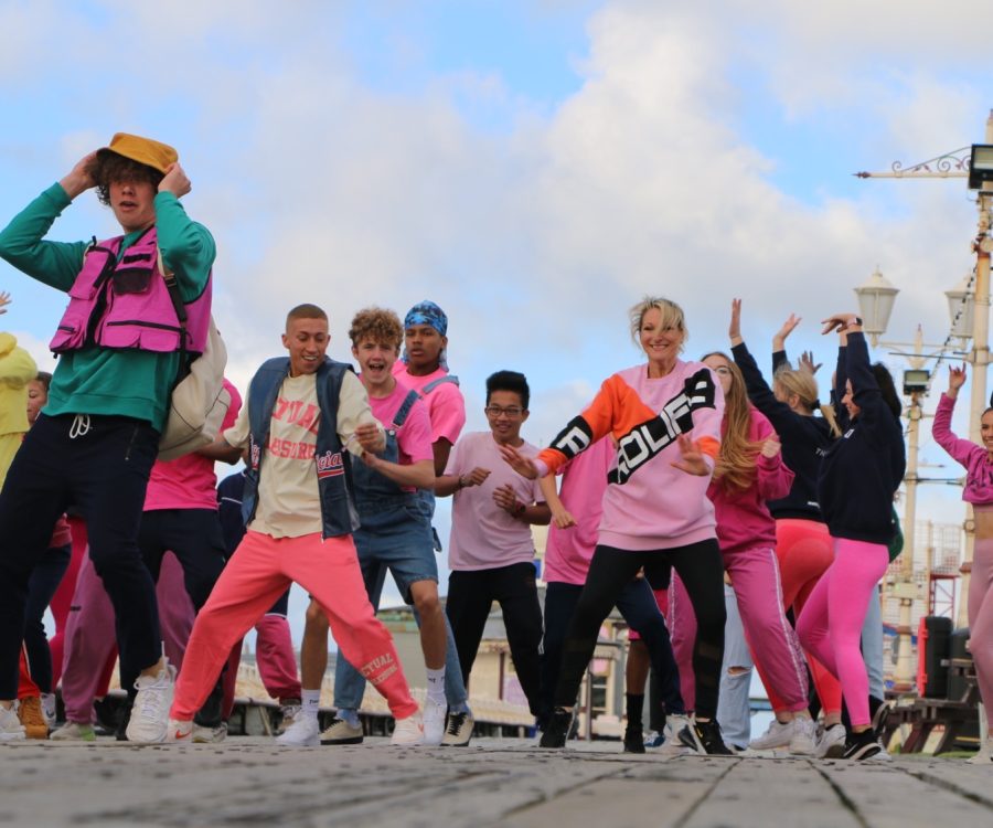 A group of people dance on the Blackpool Promenade